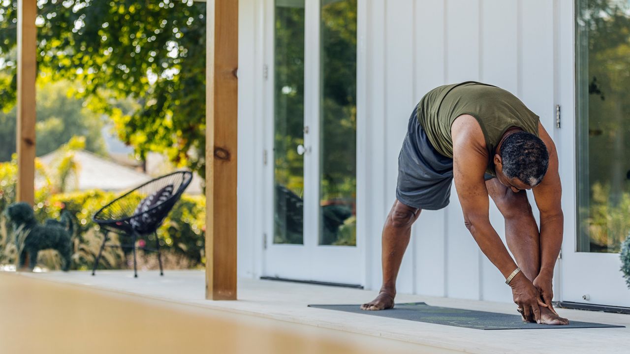 Mature man practicing yoga outdoors