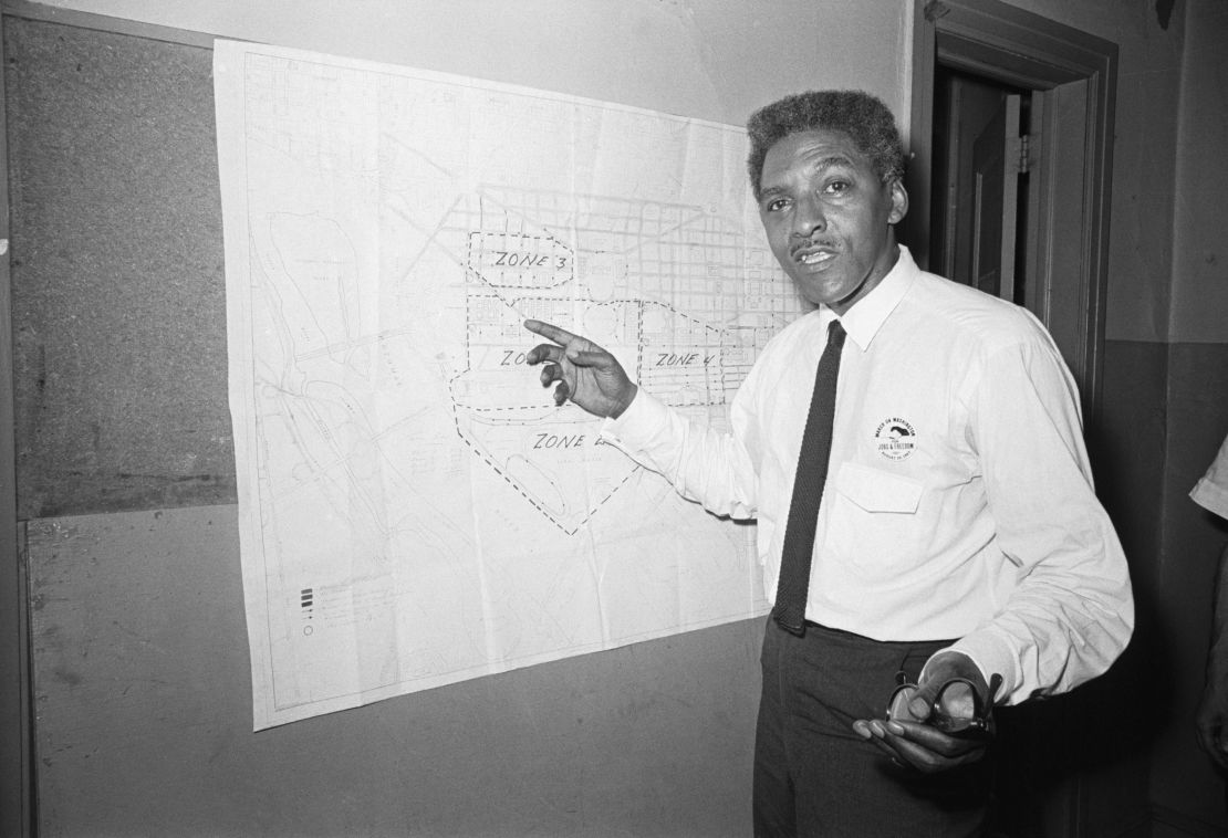 (Original Caption) 8/13/1963: Bayard Rustin, New York deputy director of the March on Washington, pointing to map explaining march route.