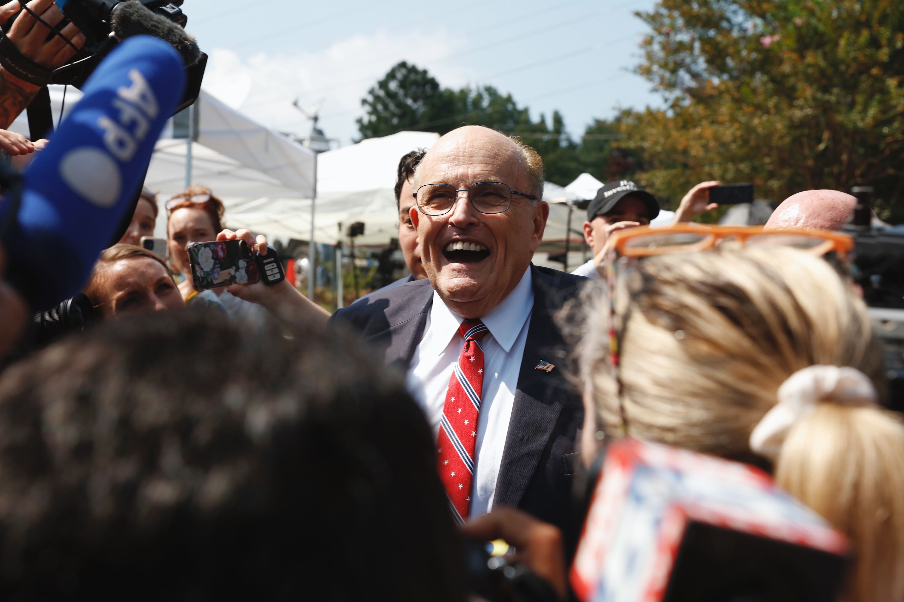 Rudy Giuliani, one of Donald Trump's most outspoken attorneys in 2020, speaks to reporters outside the Fulton County jail after he was booked in Atlanta on Wednesday, August 23. Giuliani is one of 19 co-defendants indicted in the Georgia election subversion case.