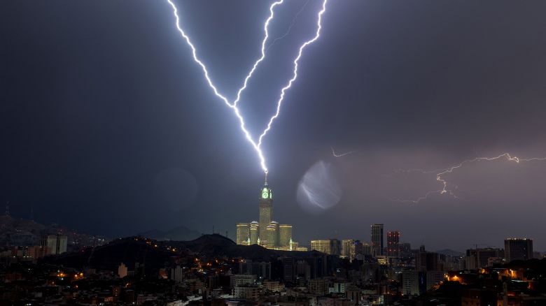 TOPSHOT - A picture taken on August 22, 2023 shows lightning over Mecca's clock tower in Saudi Arabia. Fierce storms closed schools on August 23 the desert kingdom's Mecca region, home to the holy Grand Mosque which was lashed by heavy rains and wind overnight, witnesses said. (Photo by Hammad Al-Huthali / AFP) (Photo by HAMMAD AL-HUTHALI/AFP via Getty Images)