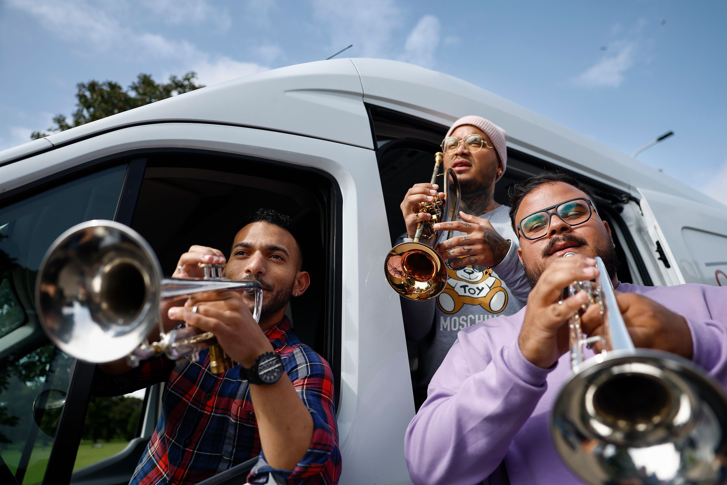 Erick Alvarez, Roderick Alvarado and Grheri Barcelo, a trio of brass musicians from the Simón Bolívar Symphony Orchestra of Venezuela, perform in Edinburgh, Scotland, on Monday, August 21. They were traveling with Care Van Edinburgh, which was offering food and support to the homeless and people in crisis.