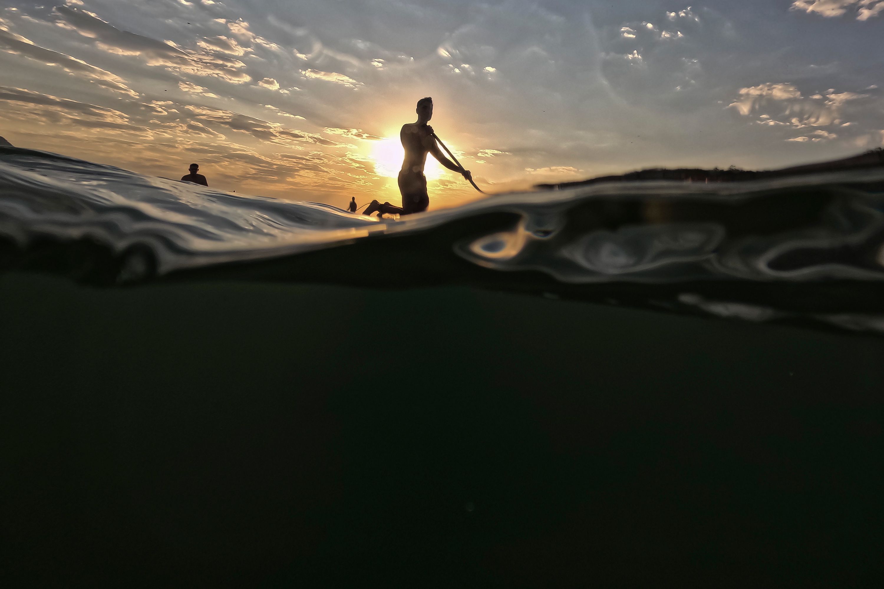 A man floats on a paddle board off the Copacabana Beach in Rio de Janeiro on Thursday, August 24.