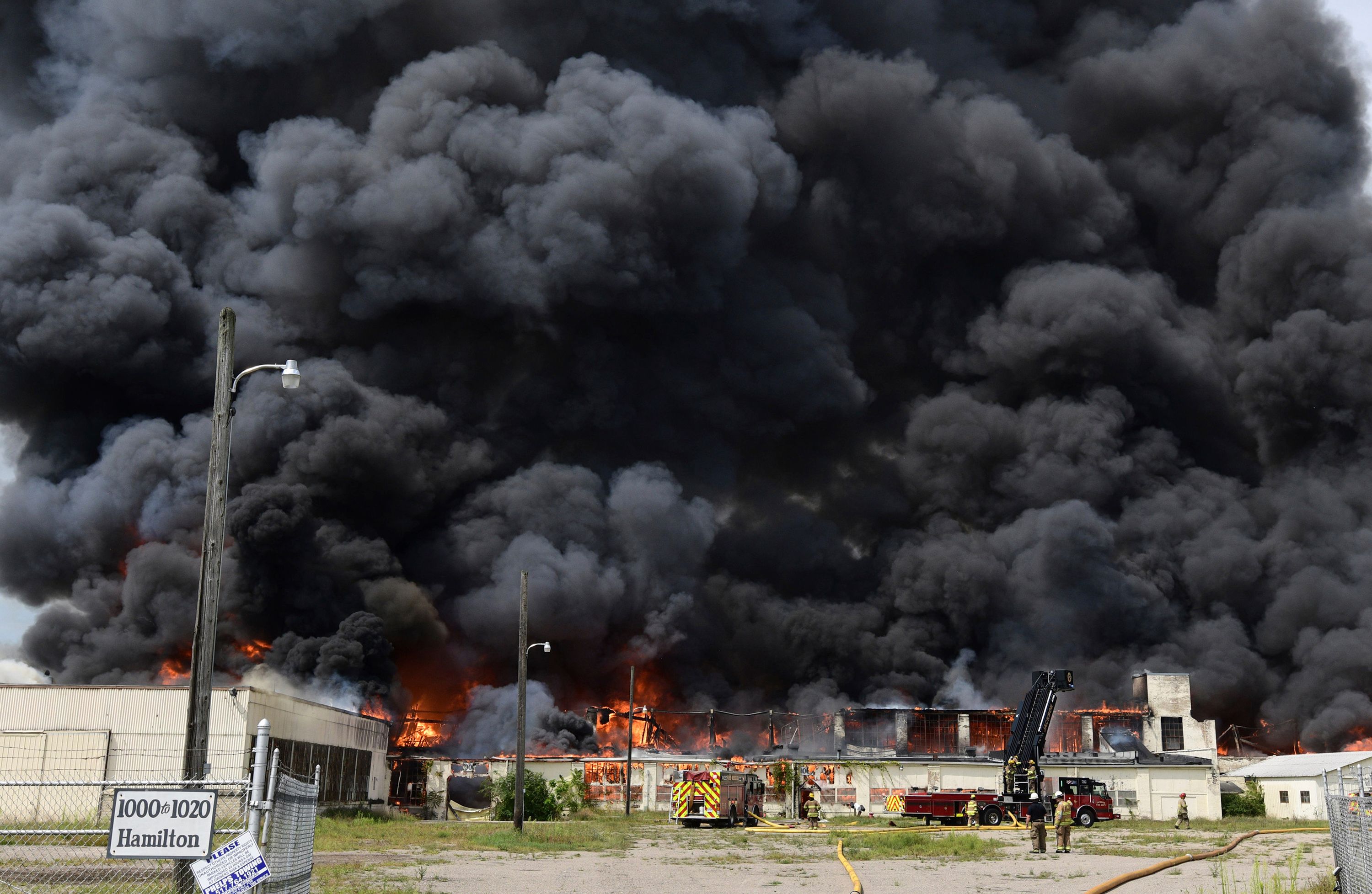 Thick smoke billows from a vacant factory in Jackson, Michigan, as firefighters battle a blaze there on Tuesday, August 22.