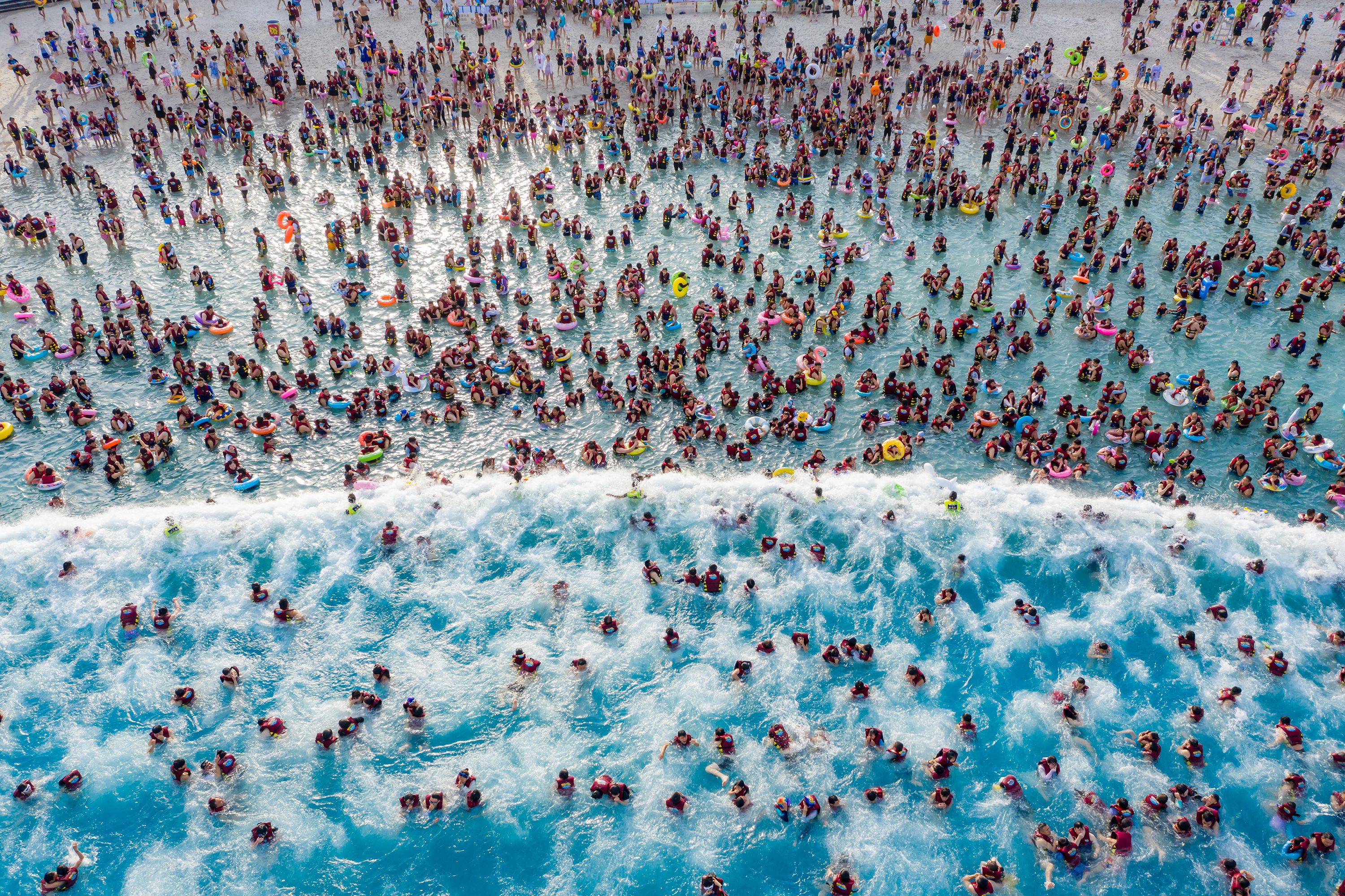 People cool off at a water park in Zhengzhou, China, on Thursday, August 17.