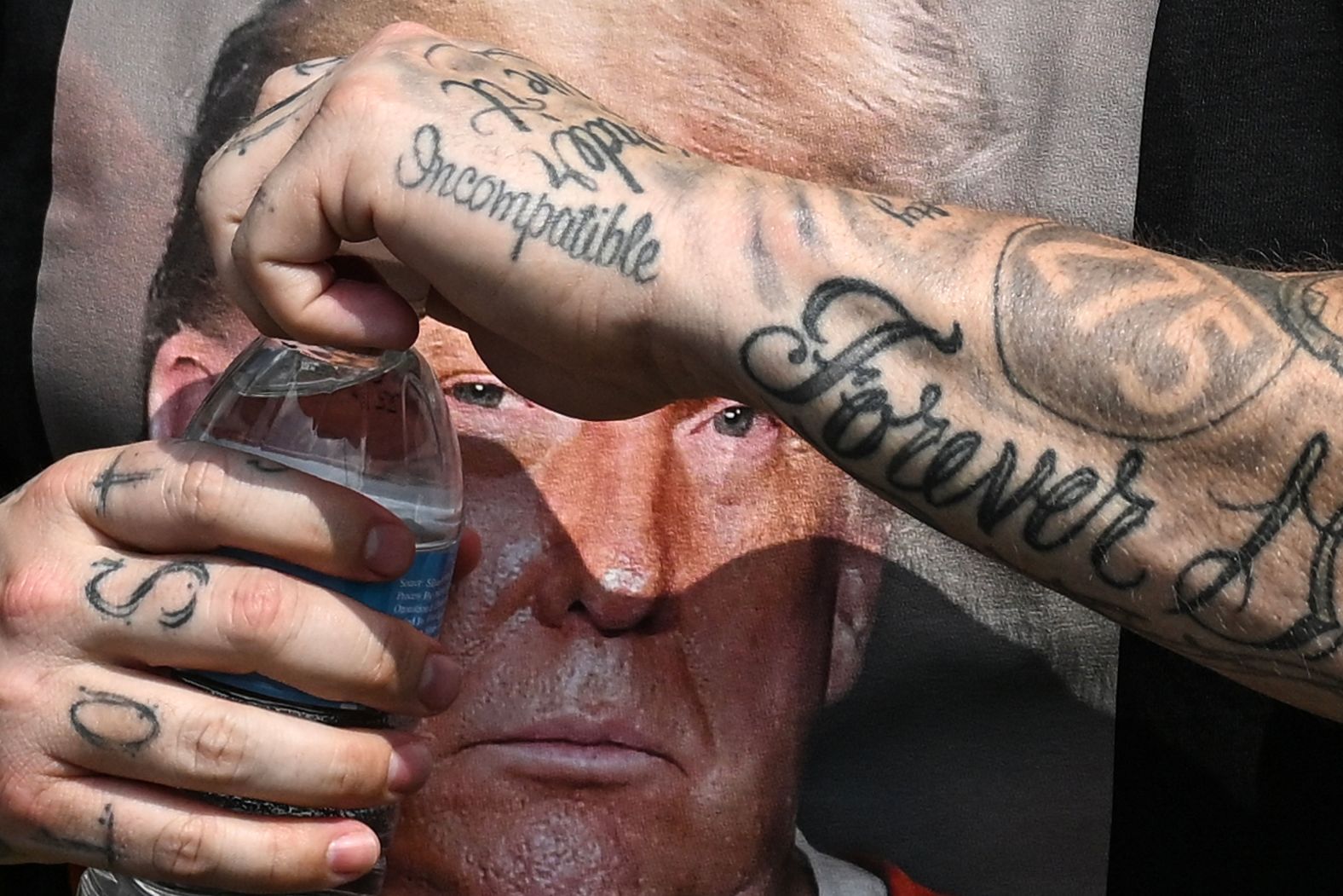 A photo of Trump is seen on a shirt as Trump supporters gathered near the jail Thursday.