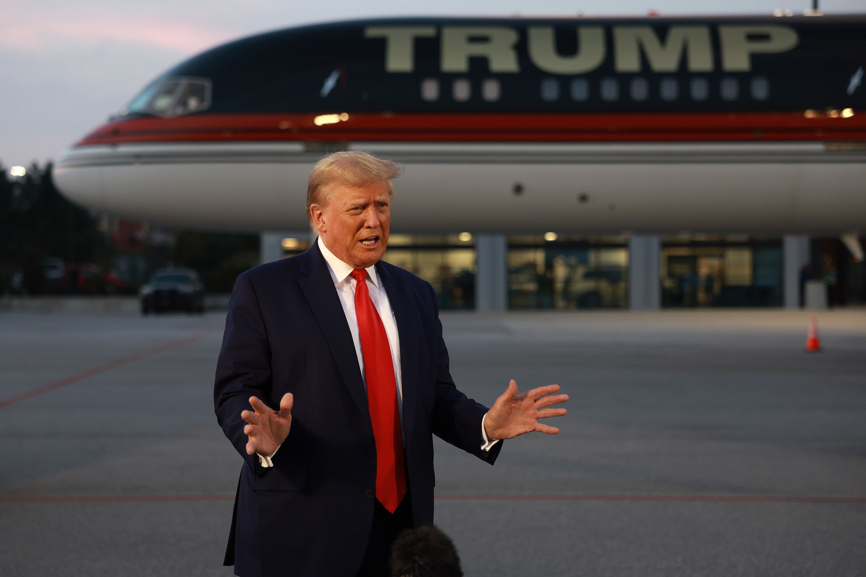 Former US President Donald Trump speaks to the media at Hartsfield-Jackson Atlanta International Airport after surrendering at the Fulton County jail on Thursday, August 24. 