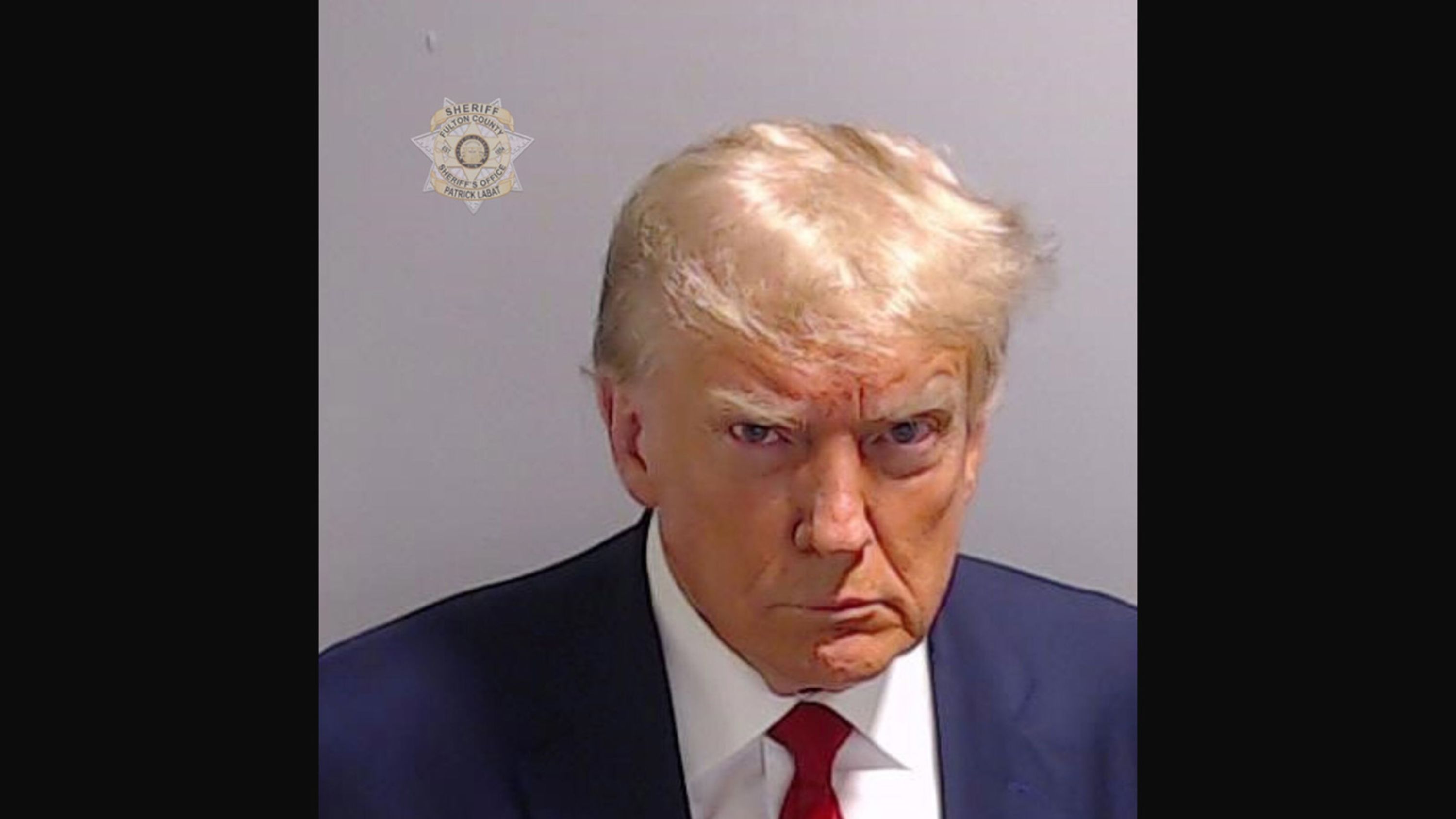 This <a href="index.php?page=&url=https%3A%2F%2Fwww.cnn.com%2F2023%2F08%2F24%2Fpolitics%2Ftrump-mug-shot-analysis%2Findex.html" target="_blank">booking photo</a> of former President Donald Trump was taken in Atlanta on Thursday, August 24. Trump was booked on more than a dozen charges stemming from his efforts to reverse Georgia's 2020 election results. His booking number was P01135809. He is the first former US president with a mug shot.
