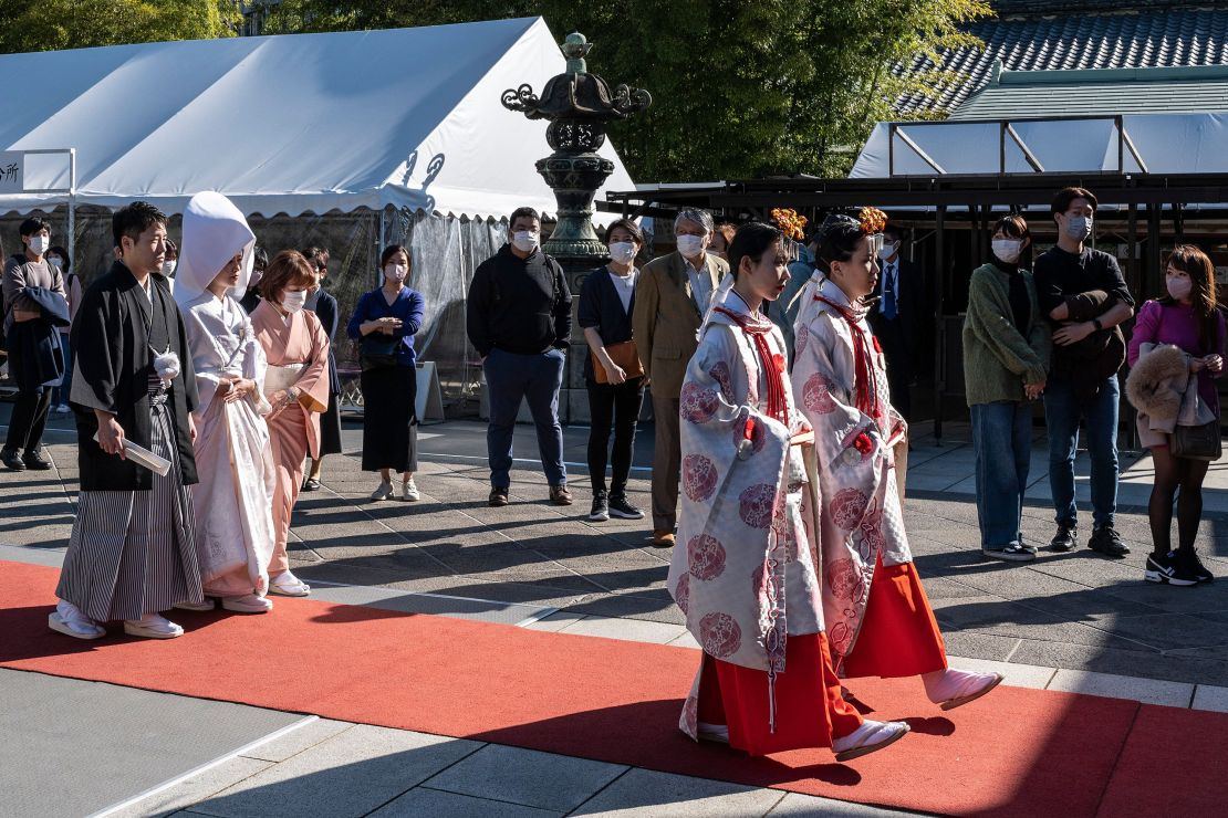 A bride and groom take part in a wedding ceremony at Hie Shrine in central Tokyo on November 3, 2022.