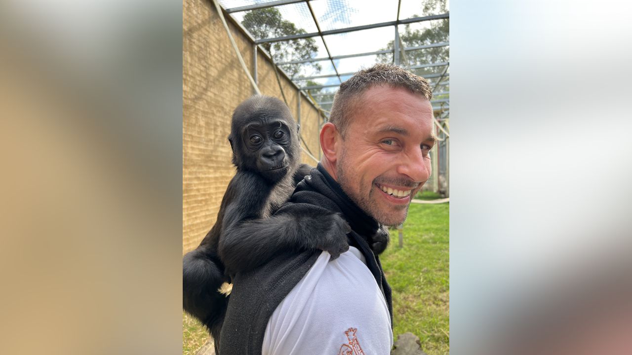 Caius clings to Chad Staples as they stroll through the zoo.
