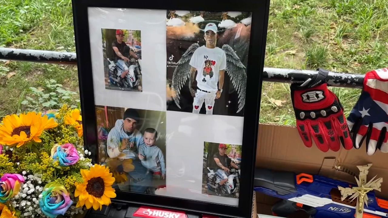 People leave photos, flowers and other items at a memorial for Eric Duprey, who died after a NYPD officer threw a picnic cooler at him. 