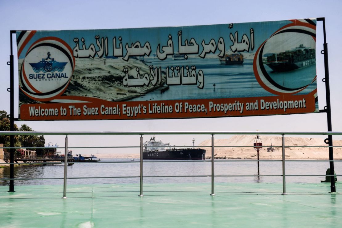 A welcoming sign is placed on the shore of the Suez Canal in the northeastern Egyptian city of Ismailiya, on May 27, 2021.