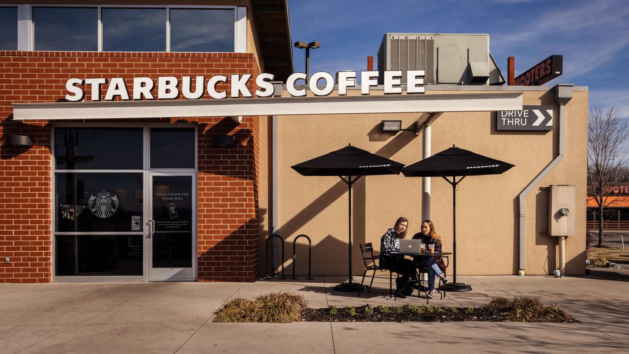 People sit outside a Starbucks in Knoxville, Tennessee, on January 12, 2022. 