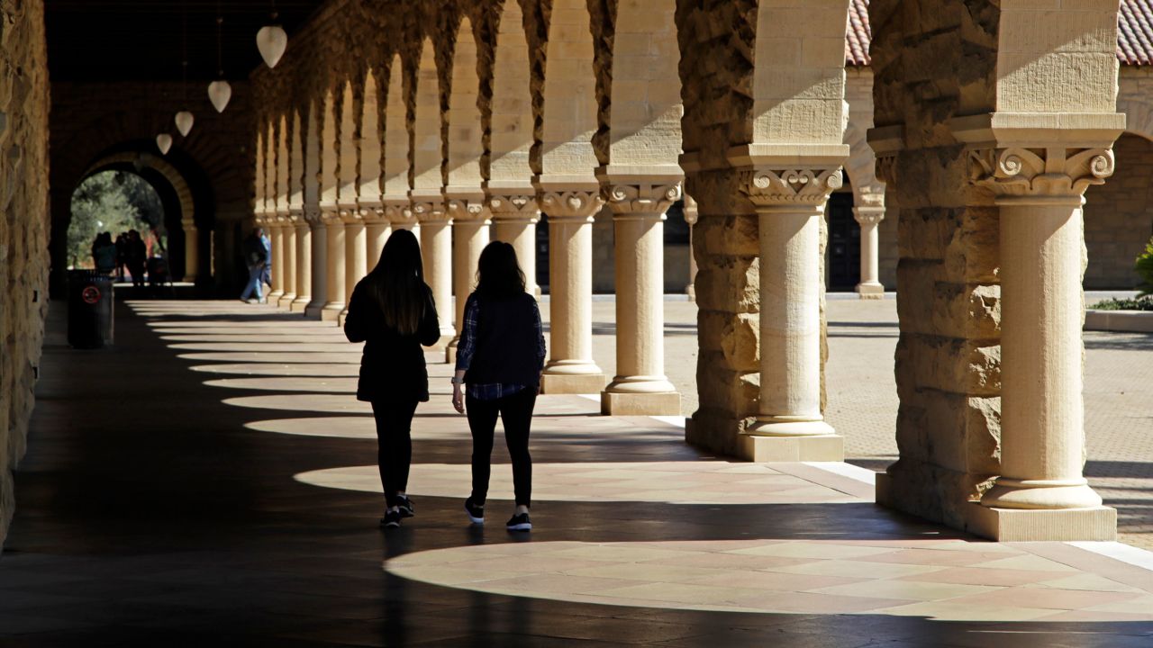 In this March 2019 photo, students walk on the Stanford University campus in Stanford, California.