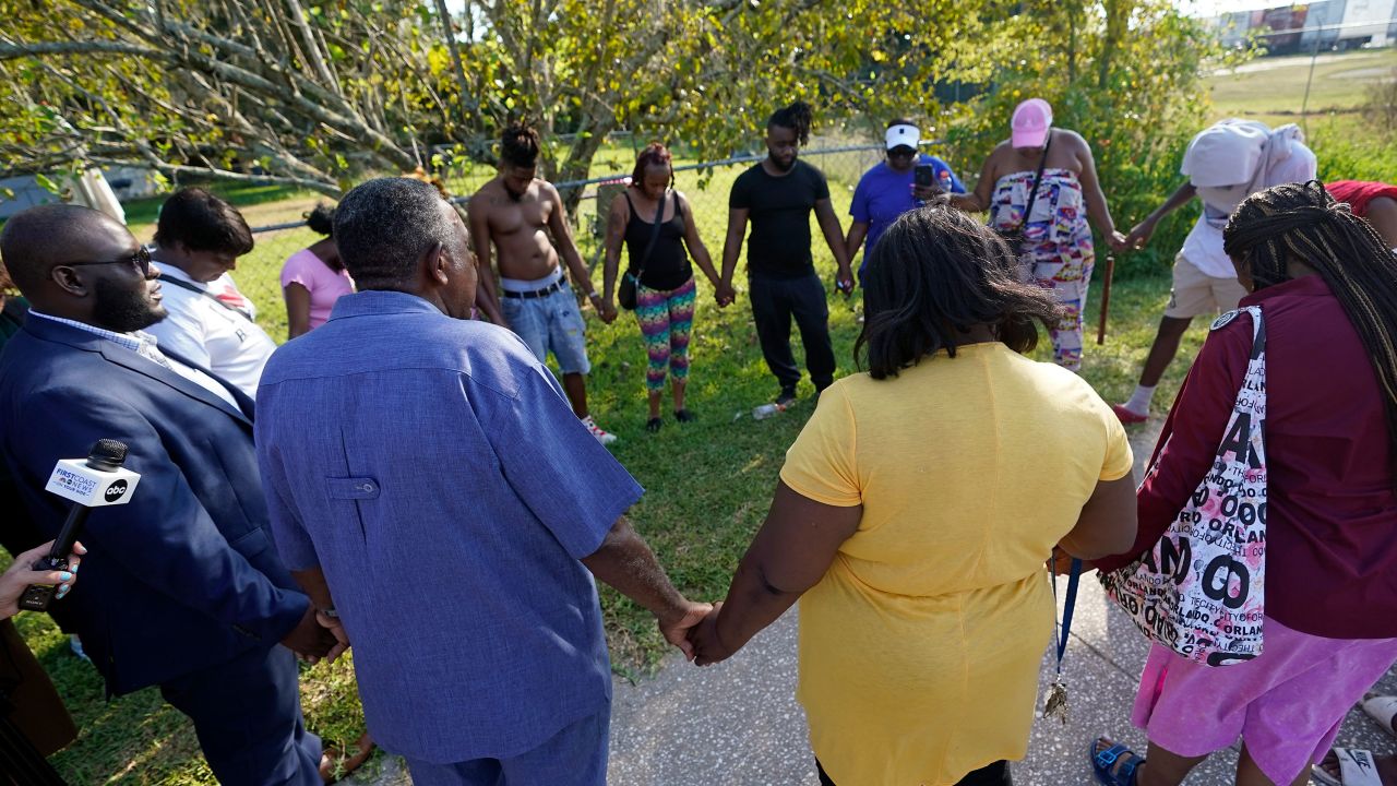Residents gather for a prayer near the scene of a shooting at a Dollar General store, Saturday, Aug. 26, 2023, in Jacksonville, Fla.