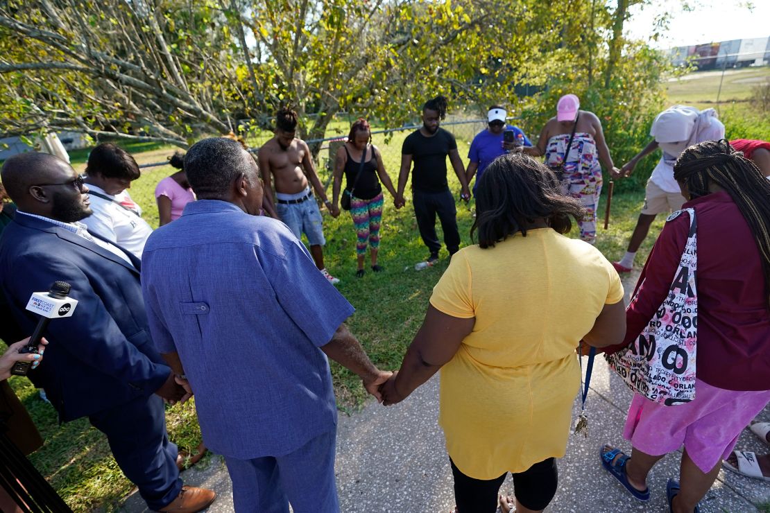 Residents gather for a prayer near the scene of a shooting at a Dollar General store, Saturday, Aug. 26, 2023, in Jacksonville, Fla. 