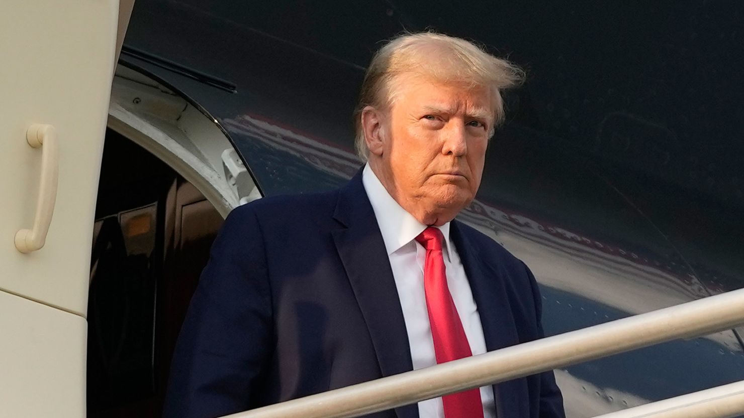 Former President Donald Trump steps off his plane as he arrives in Atlanta on August 24, 2023.