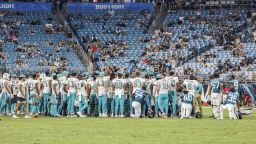Players gather on the field after an injury to Miami Dolphins wide receiver Daewood Davis during the second half of an NFL preseason football game against the Jacksonville Jaguars Saturday in Jacksonville.