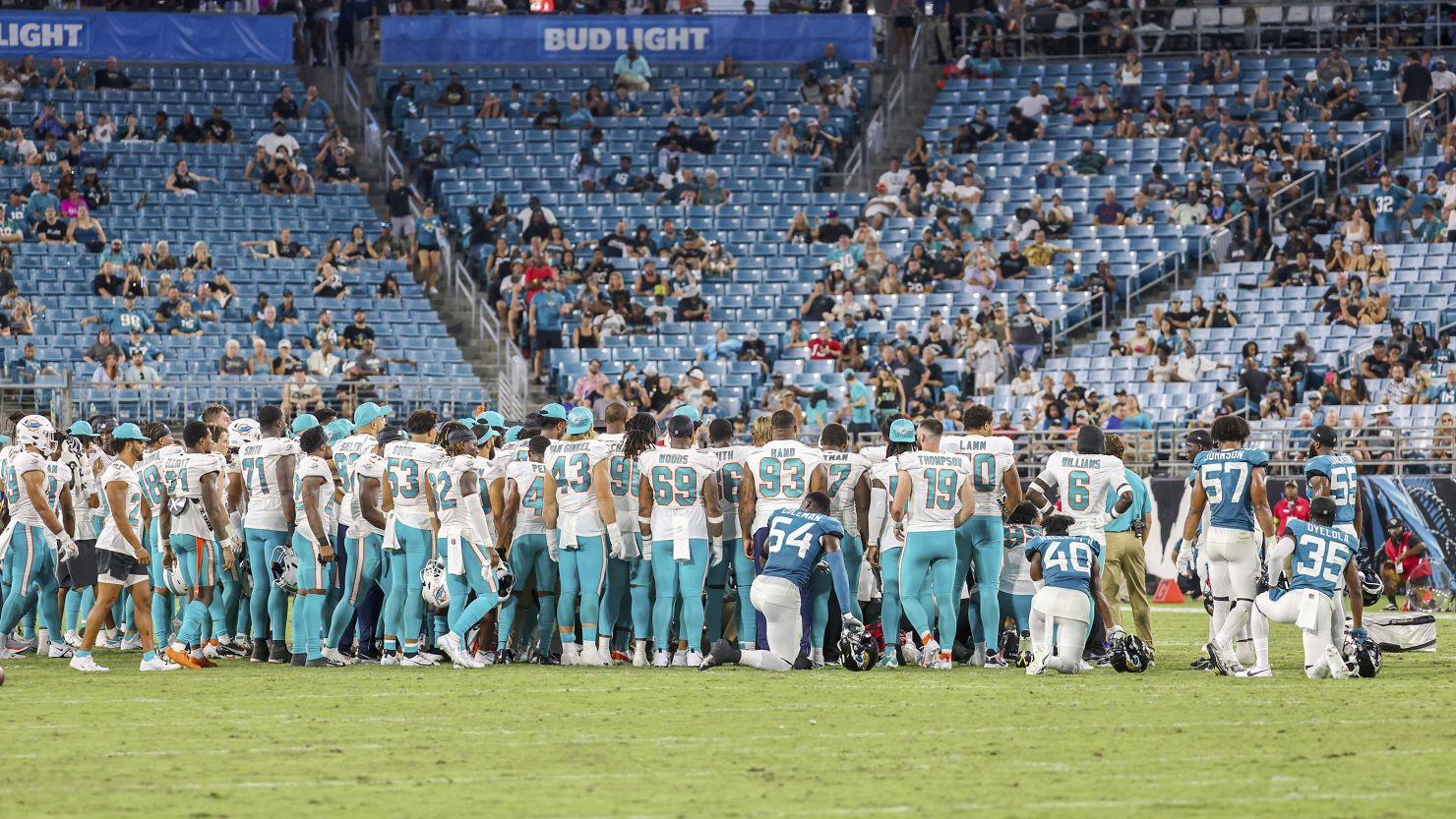 Players gather on the field after an injury to Miami Dolphins wide receiver Daewood Davis during the second half of an NFL preseason football game against the Jacksonville Jaguars Saturday in Jacksonville.