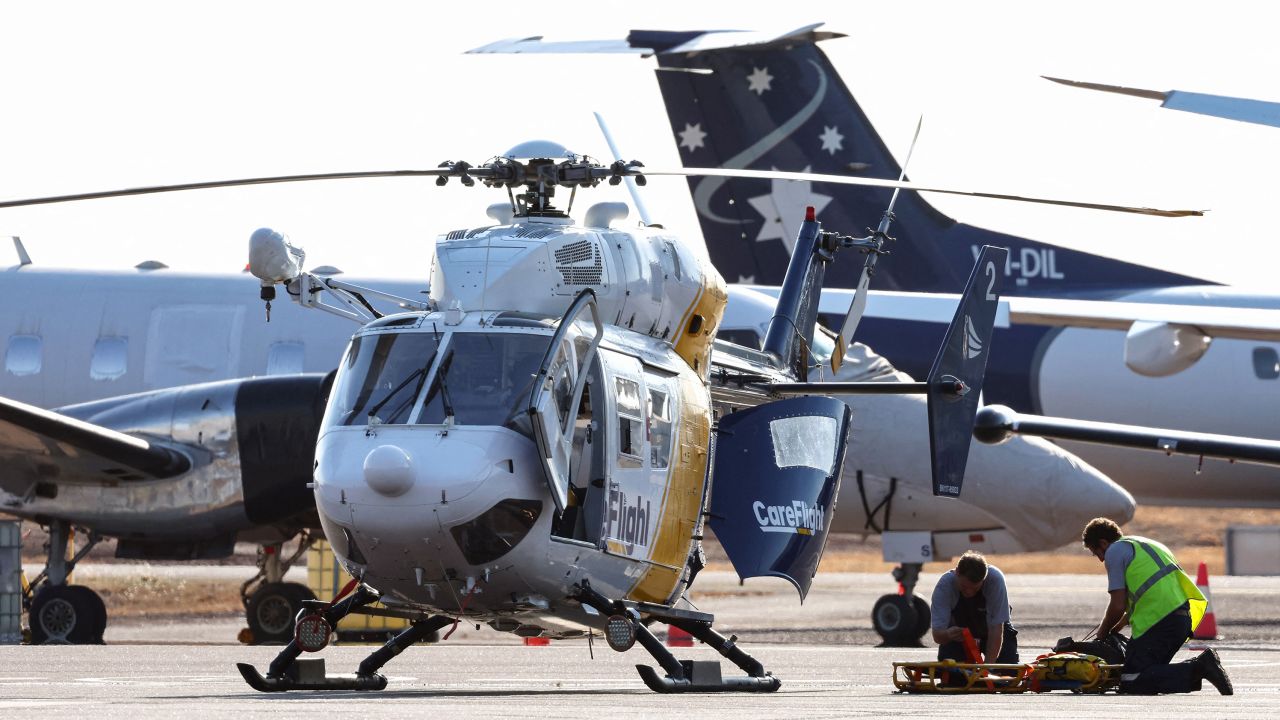 A Care Flight helicopter is seen on the tarmac of the Darwin International Airport in Darwin on August 27, 2023, as rescue work is in progress to transport those injured in the US Osprey military aircraft crash at a remote island north of Australia's mainland. Three US Marines died on August 27 after an Osprey aircraft crashed on a remote tropical island north of Australia during war games, US military officials said. (Photo by DAVID GRAY / AFP) (Photo by DAVID GRAY/AFP via Getty Images)