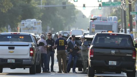 Law enforcement officials investigate the scene of a mass shooting at a Dollar General store, Saturday, Aug. 26, 2023, in Jacksonville, Fla. (AP Photo/John Raoux)