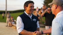 Ron DeSantis, governor of Florida and 2024 Republican presidential candidate, shakes hands with an attendee during a campaign stop at the Field of Dreams in Dyersville, Iowa, US, on Thursday, Aug. 24, 2023. Republican candidates this week battled each other over the economy in their first debate of the 2024 race, waging attacks on President Joe Biden's policies while seeking to gain ground on the absent GOP frontrunner Donald Trump. Photographer: Al Drago/Bloomberg via Getty Images
