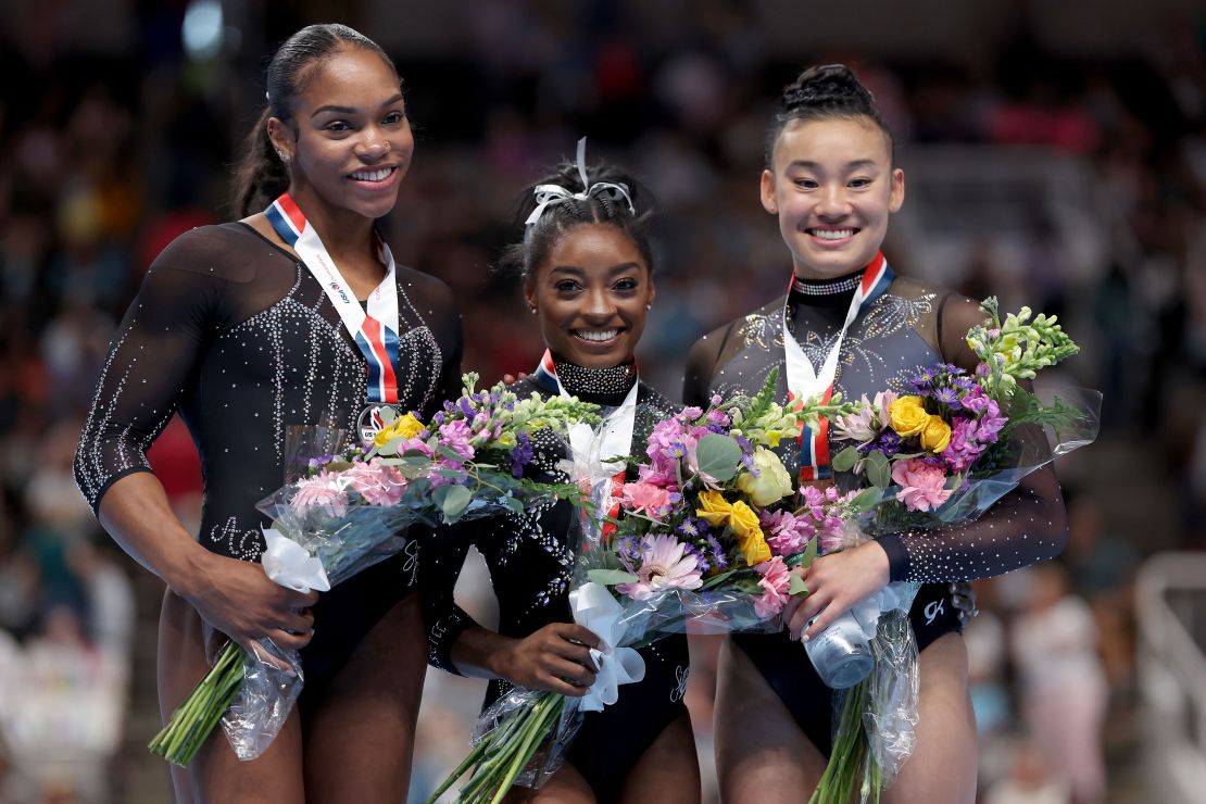Simone Biles (center) poses with Shilese Jones (left) and Leanne Wong on the podium after the three medaled at the US Gymnastics Championships on Sunday. 