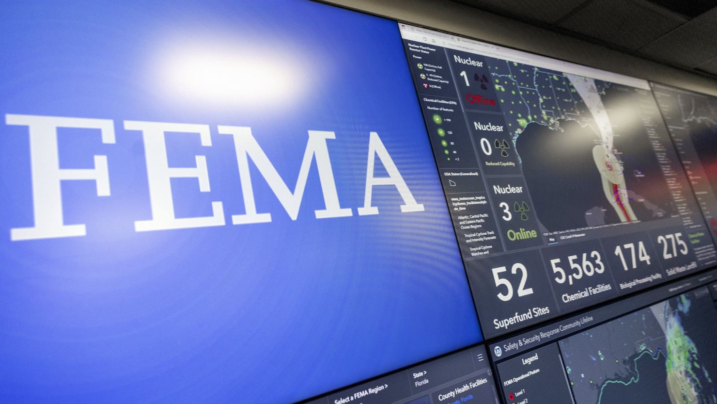 Screens display information on Hurricane Ian inside the National Response Coordination Center at FEMA headquarters in September 2022.
