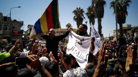 People protest in as-Suwayda, regime-held Syria on Thursday.