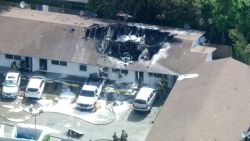 Firefighters work at the site of a helicopter crash in Pompano Beach, Florida, on Monday, August 28.