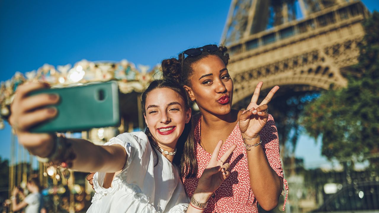 Shot of two happy young women taking selfies together at a carnival