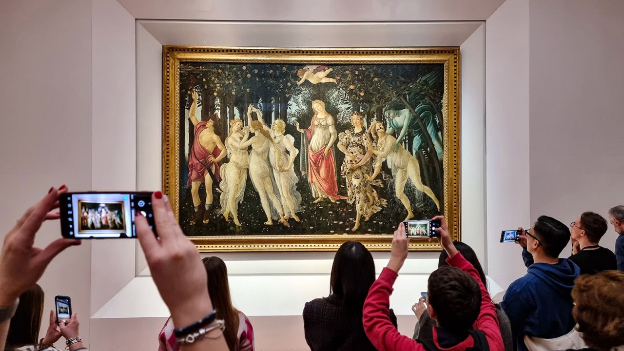 FLORENCE, ITALY - DECEMBER 30: Visitors view and photograph the painting Primavera (Spring)  by the 15th century Italian Renaissance artist Sandro Botticelli at the Uffizi Gallery on December 30, 2022 in Florence, the capital of Italy's Tuscany region. The 16th century museum is famous for its collection of ancient sculptures and its paintings that date from the Middle Ages to the Modern period. (Photo by David Silverman/Getty Images)