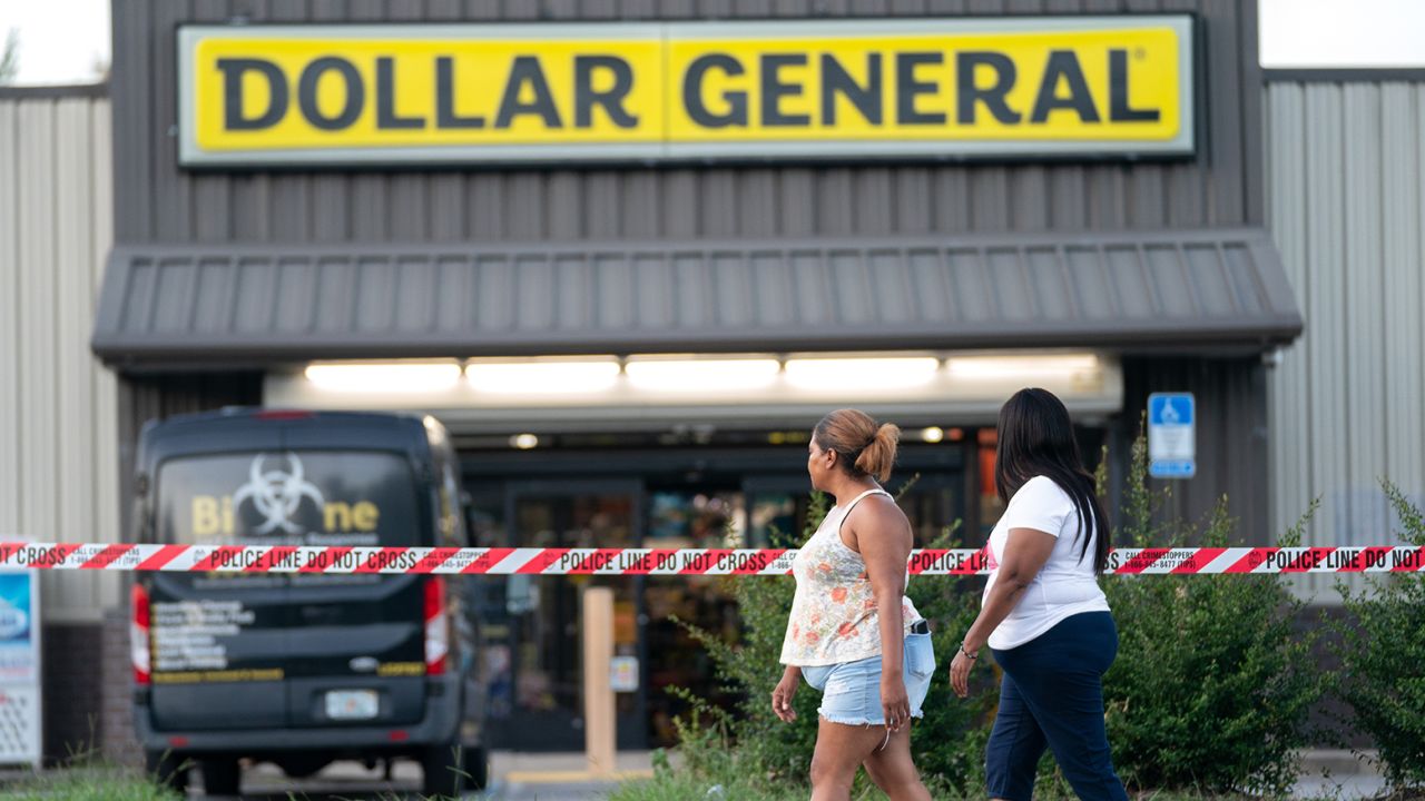 People walk past the Dollar General store Sunday in Jacksonville, Florida. 