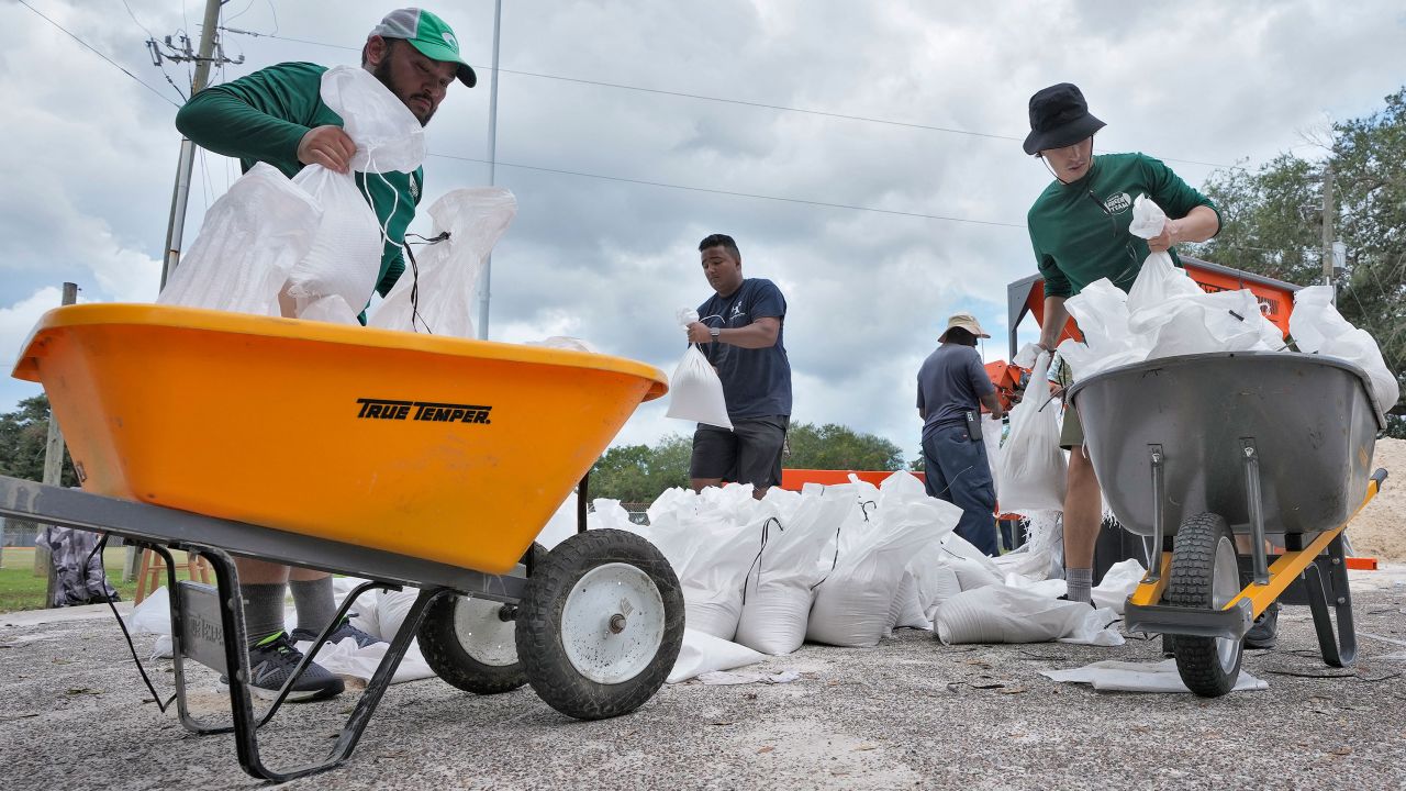 Members of the Tampa, Fla., Parks and Recreation Dept., help residents with sandbags Monday, Aug. 28, 2023, in Tampa, Fla. 