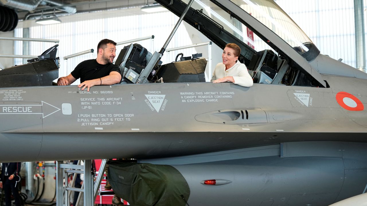Ukrainian President Volodymyr Zelenskiy and Denmark's Prime Minister Mette Frederiksen pictured sitting in an F-16.