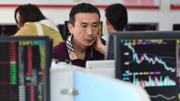 Investors monitor stock price movements at a securities company in Fuyang, in China's eastern Anhui province on August 28, 2023. 