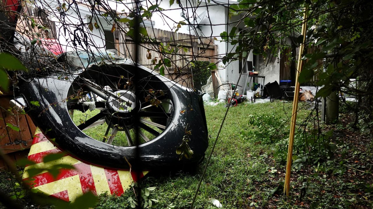 The helicopter's tail rotor is seen in the backyard of a home after the crash.