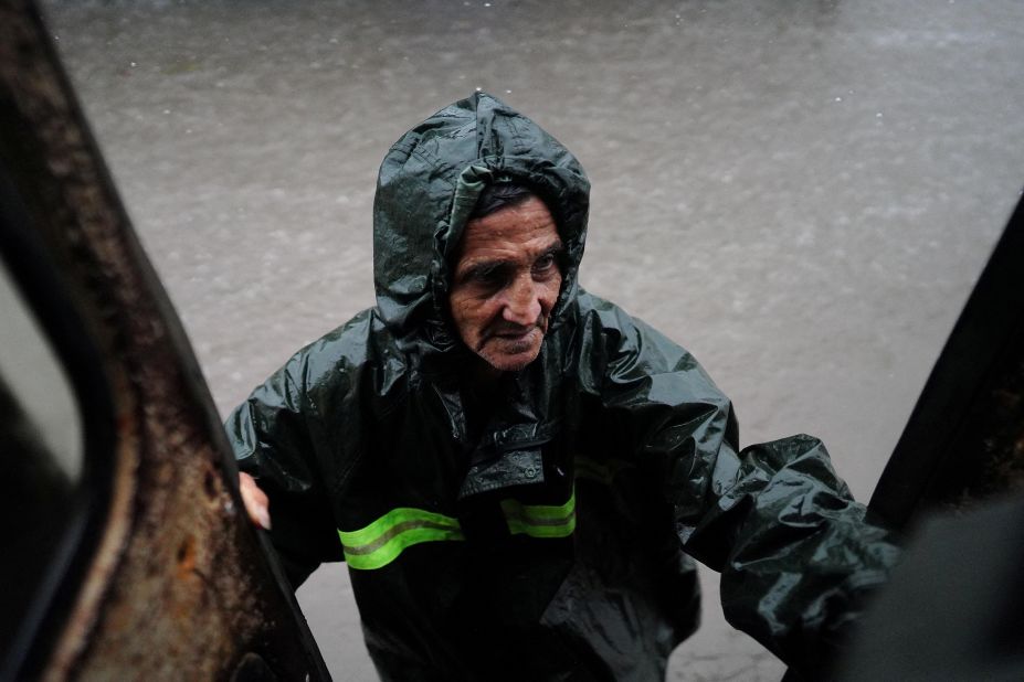 A man is evacuated from a flooded street as Idalia made landfall in Guanimar, Cuba, on August 28.