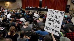 A gay and transgender students rights supporter holds a sign during a board meeting of the Chino Valley Unified School District at Don Lugo High School in Chino on July 20, 2023.