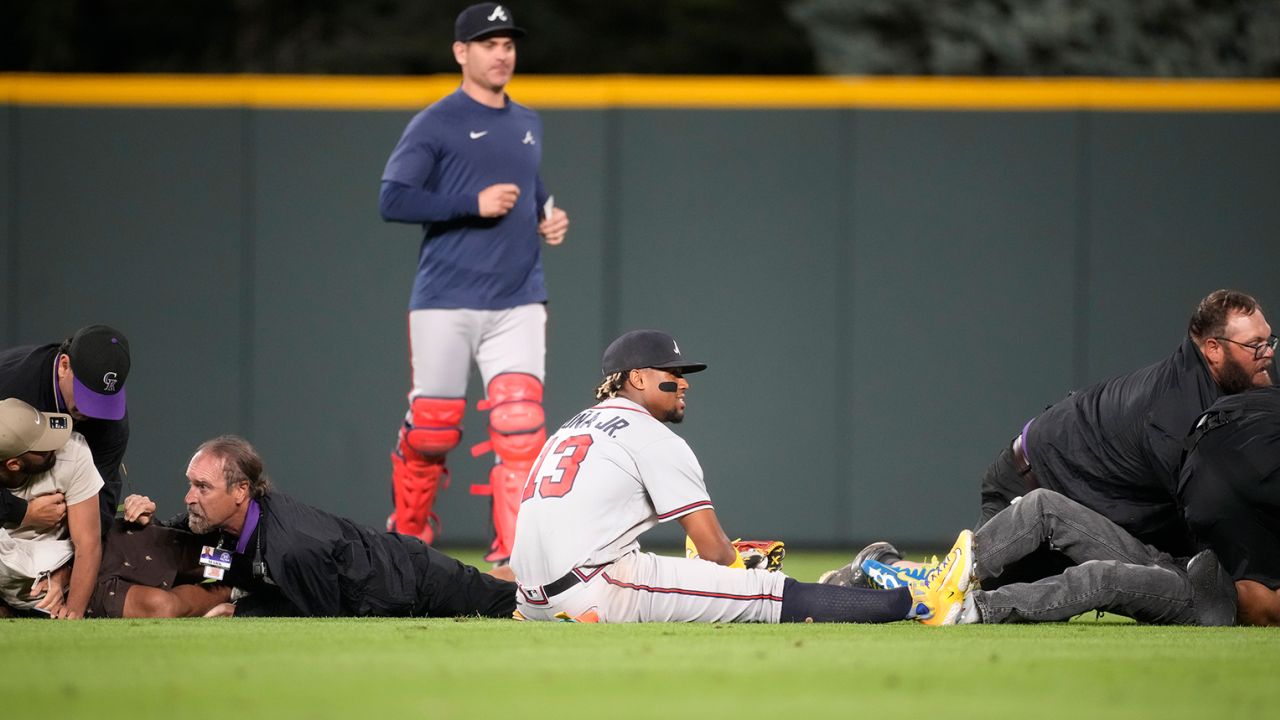 Atlanta Braves' Ronald Acuña Jr. knocked to the ground after two