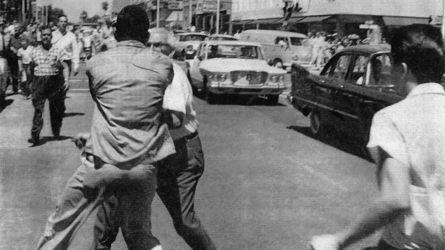 A man later identified as Charlie Griffin is accosted and later struck in the head with an ax handle on a downtown Jacksonville street during civil unrest on August 27, 1960.