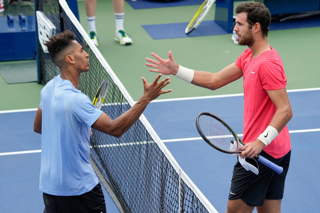 Michael Mmoh, of the United States, left, shakes hands with Karen Khachanov, of Russia, after defeating Khachanov during the first round of the U.S. Open tennis championships, Tuesday, Aug. 29, 2023, in New York. (AP Photo/John Minchillo)