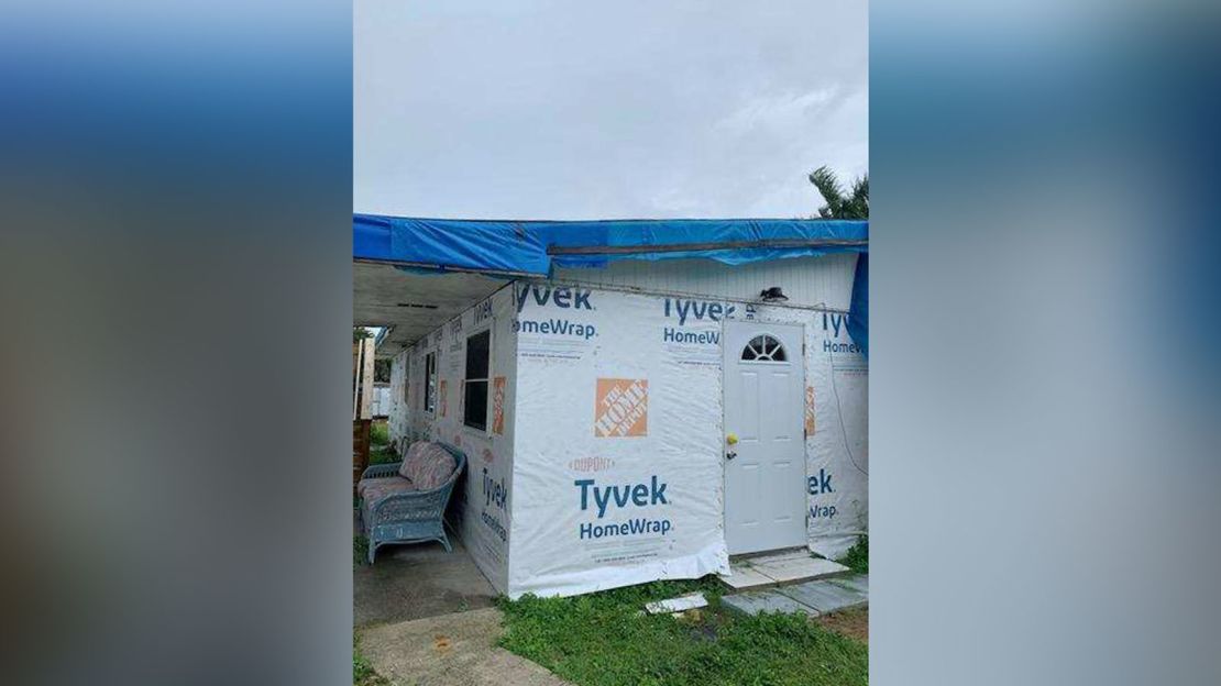 A blue tarp is a temporary roof for the Manns' house in St. James City.