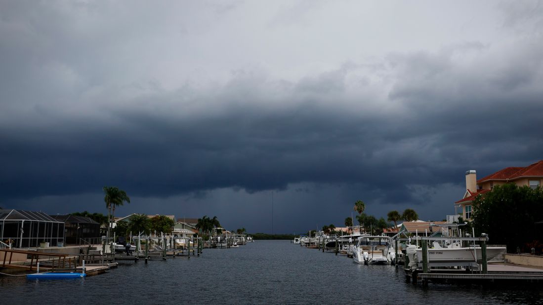 Storm clouds are seen over a canal in Port Richey, Florida, on Tuesday, August 29.