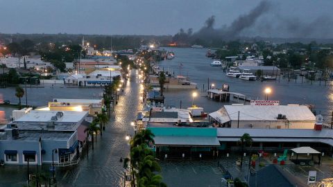 In an aerial view, a fire is seen as flood waters inundate the downtown area after Hurricane Idalia passed offshore on August 30, 2023 in Tarpon Springs, Florida. Hurricane Idalia is hitting the Big Bend area of Florida. 