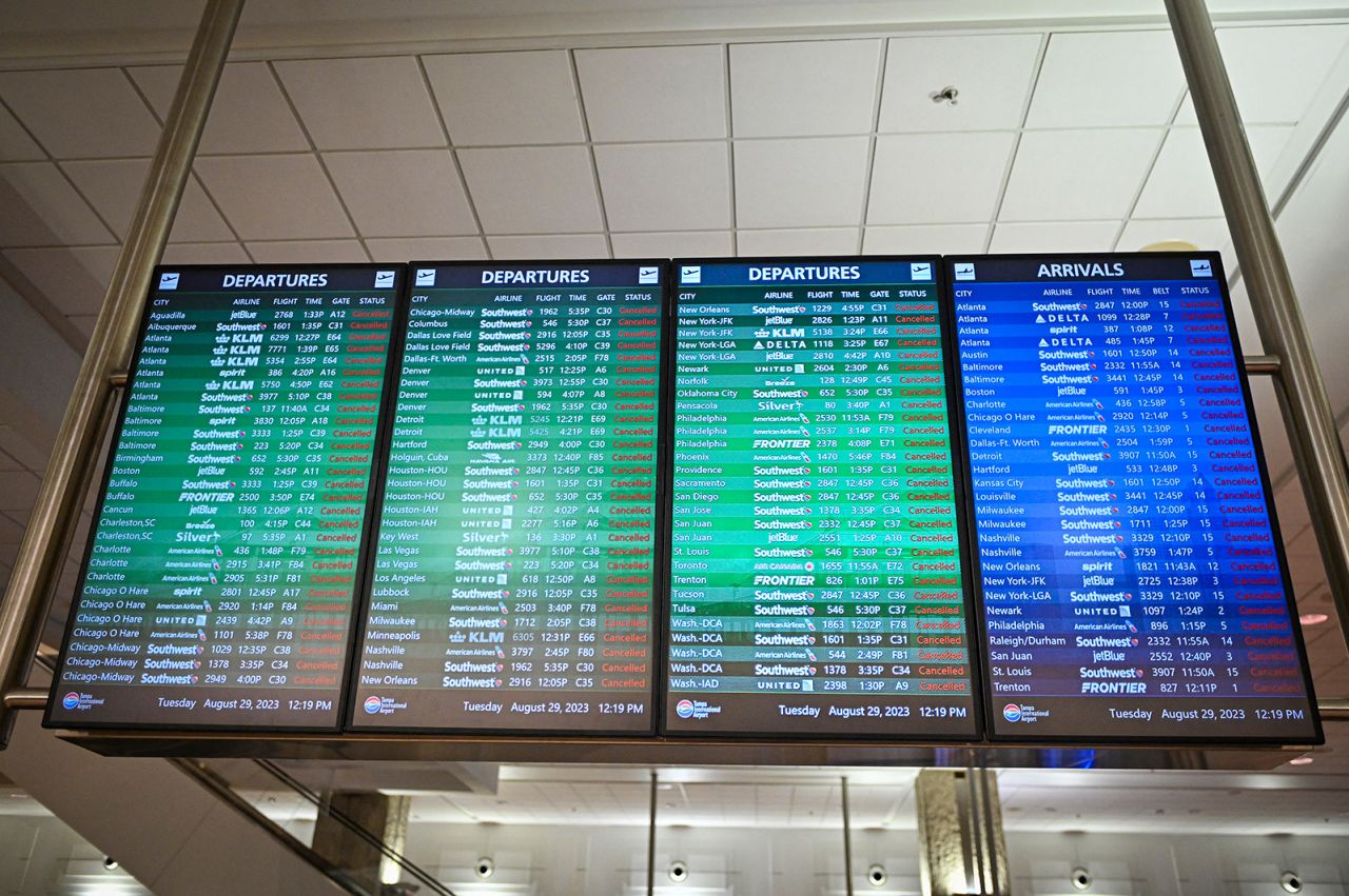 TOPSHOT - A banner showing all canceled flights at the closed Tampa International Airport in Tampa, Florida, on August 29, 2023, as the city prepares for Hurricane Adalia.  Hurricane Adalia intensified on Tuesday as it moved toward Florida's west coast, prompting mass evacuation orders and flood alerts, as authorities warned of a life-threatening ocean rise and catastrophic damage when the storm came ashore early Wednesday.  (Photo by Miguel J. Rodriguez Carrillo/Miguel J. Rodriguez Carrillo/AFP) (Photo by Miguel J. Rodriguez Carrillo/Miguel J. Rodriguez Carrillo/AFP via Getty Images)