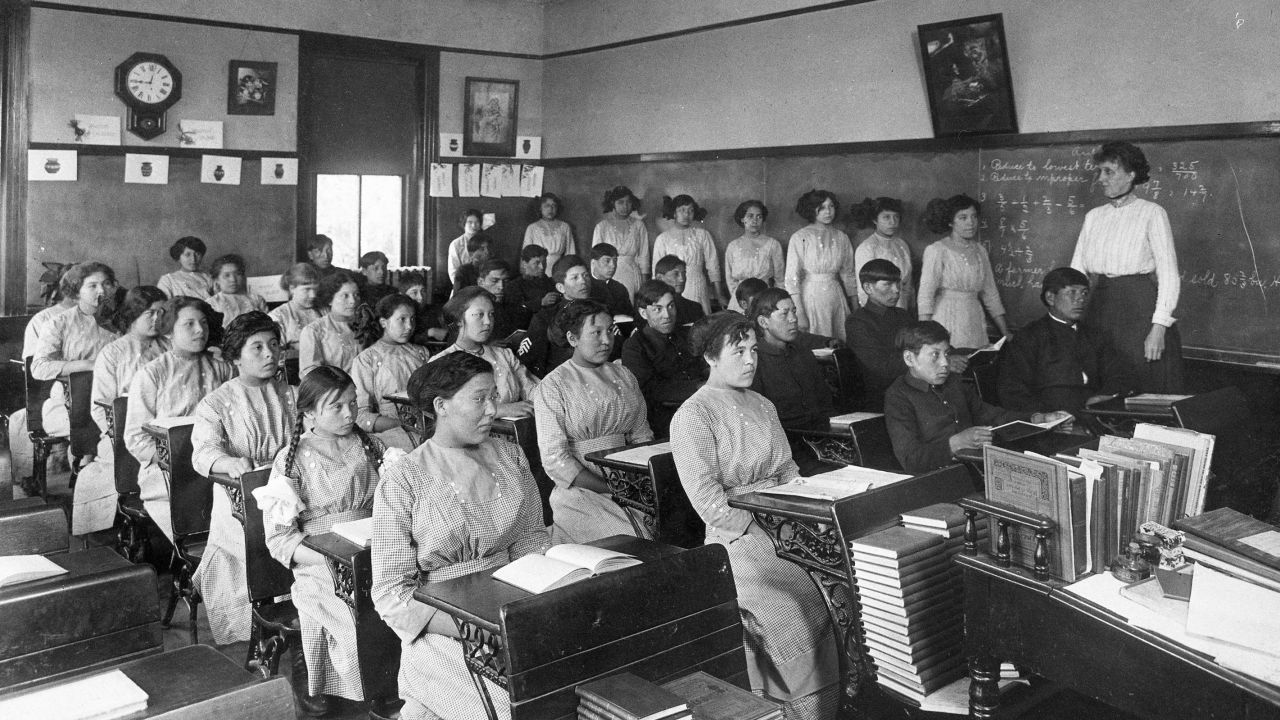 In this undated photo provided by National Archives, fourth grade students sit in a classroom at the former Genoa Indian Industrial School in Genoa, Nebraska. 
