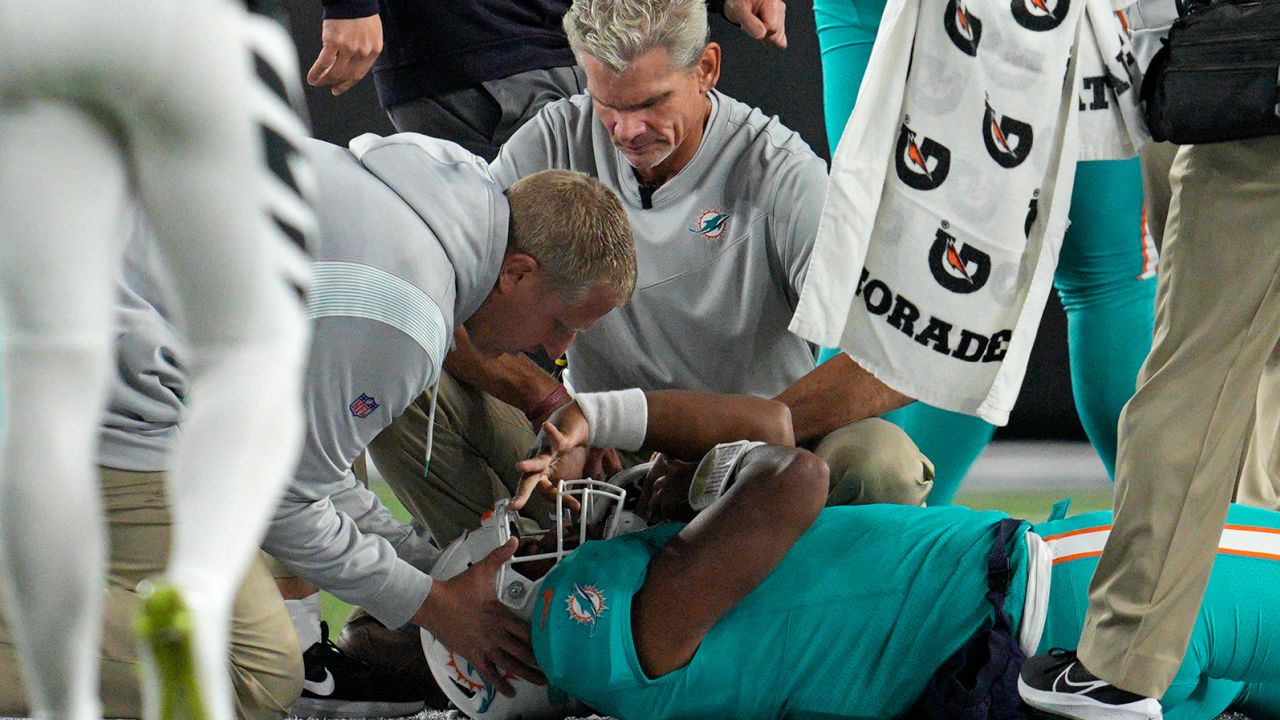 Miami Dolphins quarterback Tua Tagovailoa is examined during the first half of the team's NFL football game against the Cincinnati Bengals, Thursday, Sept. 29, 2022, in Cincinnati.