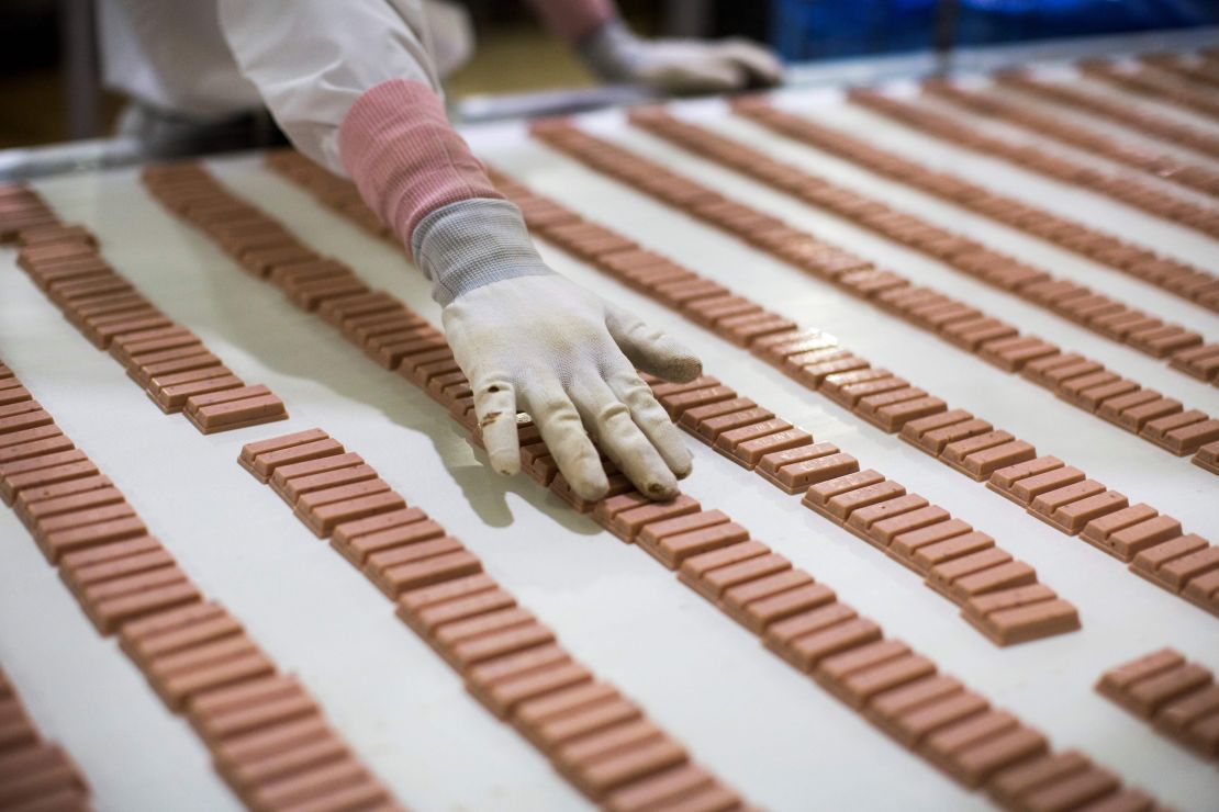 A Japanese worker checks strawberry flavor Kit Kat bars in 2017.