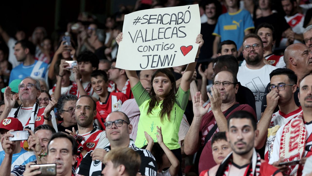A girl holds a sign reading 'It's over ('se acabo'), Vallecas with you Jenni' prior the Spanish Liga football match between Rayo Vallecano de Madrid and Club Atletico de Madrid at the Vallecas stadium in Madrid on August 28, 2023. A growing number of voices denounce the Spain's football federation president Luis Rubiales after his forced kiss on Spain's midfielder Jenni Hermoso's lips at women's World Cup final. Rubiales was provisionally suspended by FIFA for 90 days on August 26, and Spain's prosecutors opened a preliminary sex abuse probe on August 28. (Photo by Thomas COEX / AFP) (Photo by THOMAS COEX/AFP via Getty Images)