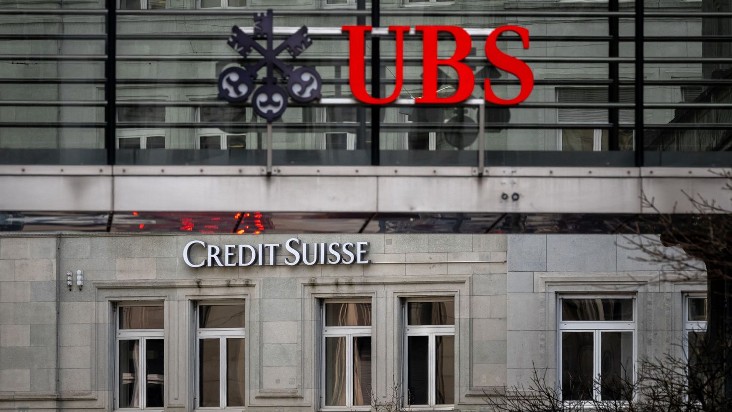 A sign of Credit Suisse behind a sign of UBS in Zurich, Switzerland, seen on March 18, 2023
